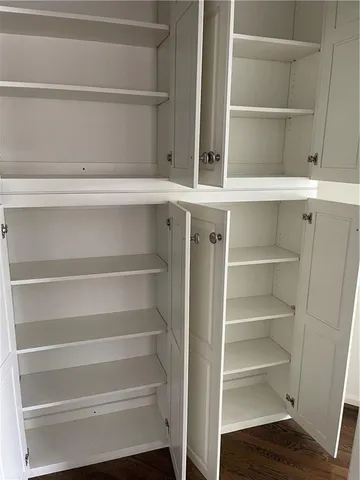 a view of walk in closet with empty racks