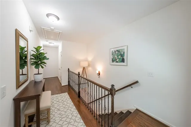 a view of hallway with wooden floor and a potted plant