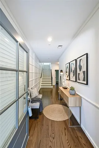 a living room with furniture a rug and a wooden floor
