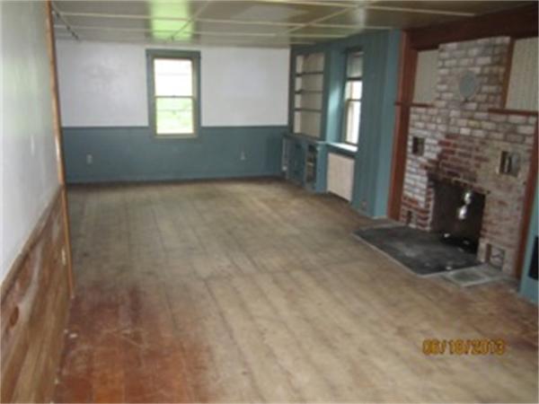 3 Bates Road Cummington, MA 01026 - Photo 13 of 15 a view of an empty room with a fireplace and a window