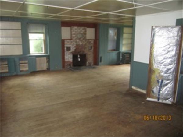 3 Bates Road Cummington, MA 01026 - Photo 10 of 15 an empty room with windows and fireplace