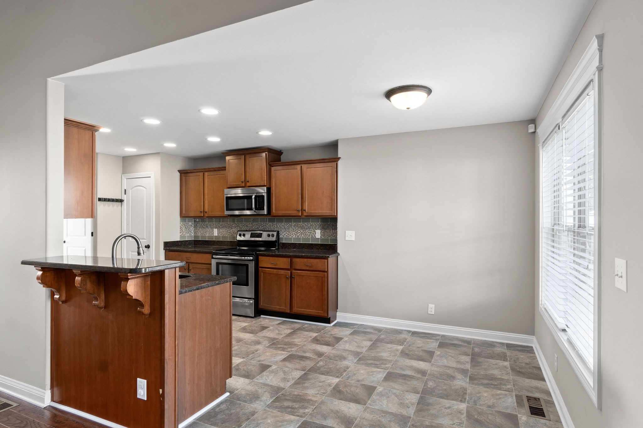 3782 Suiter Road Clarksville, TN 37040 - Photo 11 of 32 a kitchen with stainless steel appliances granite countertop a refrigerator and a sink