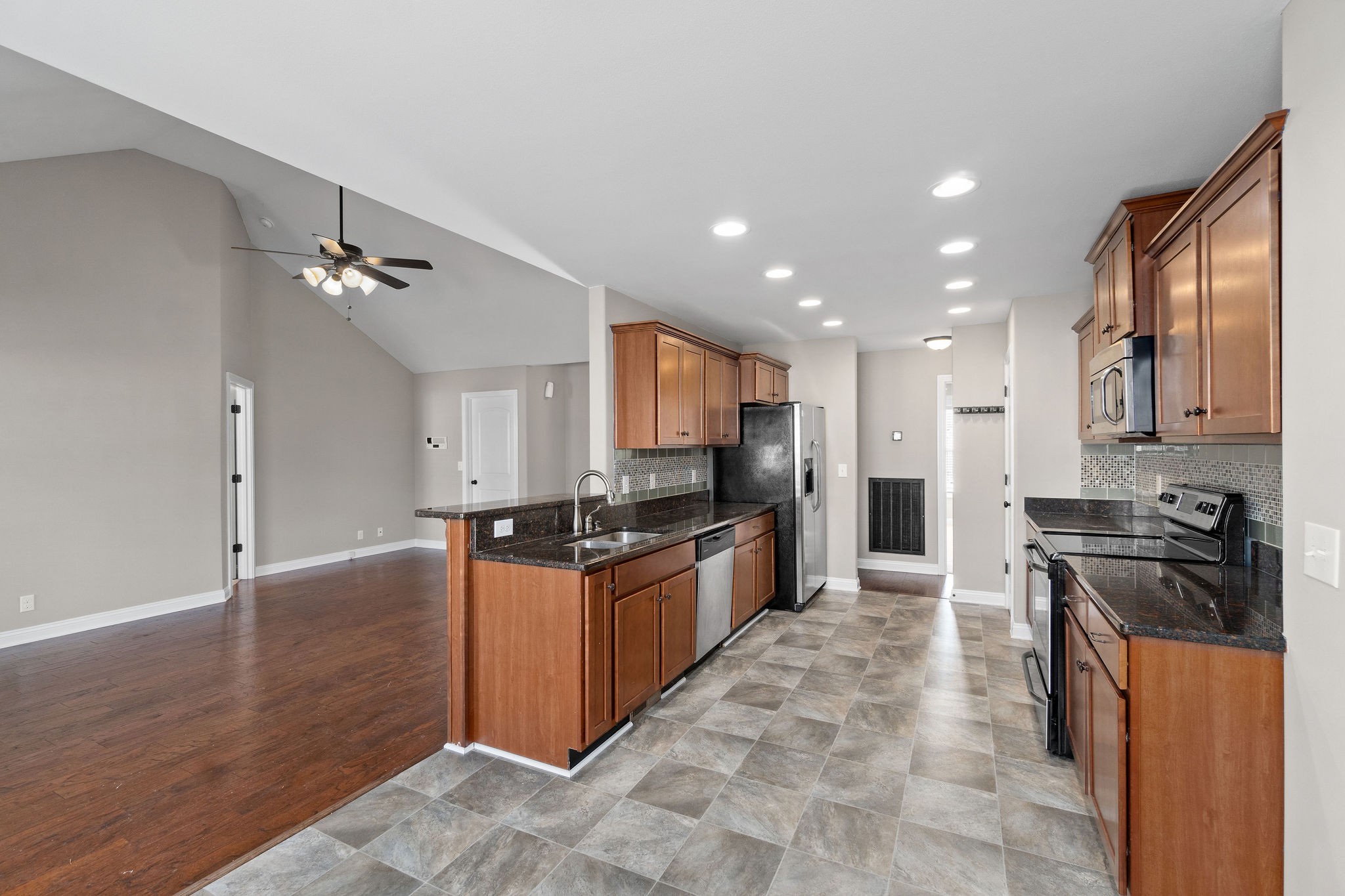 3782 Suiter Road Clarksville, TN 37040 - Photo 13 of 32 a kitchen with granite countertop a stove top oven and cabinets
