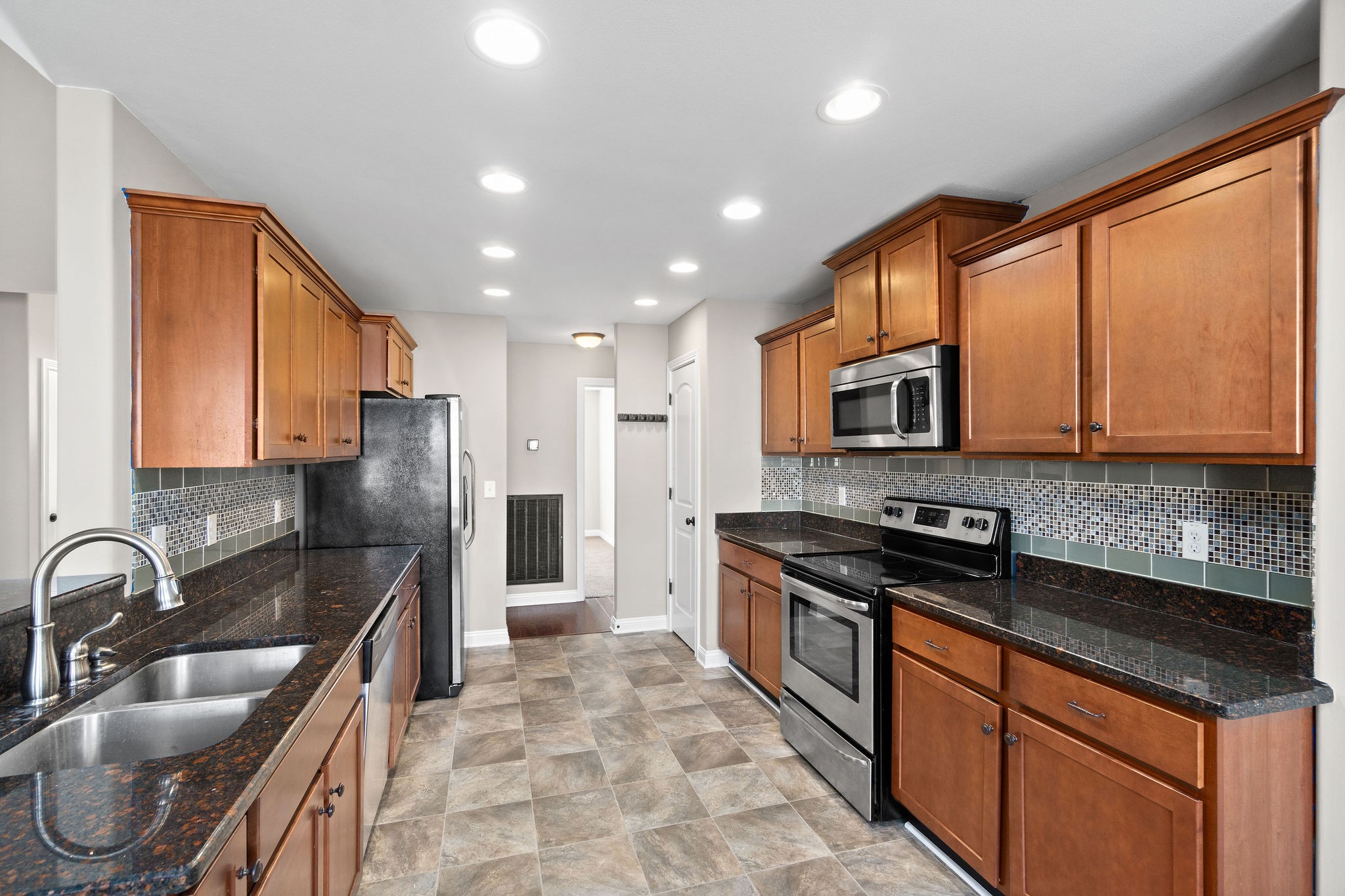3782 Suiter Road Clarksville, TN 37040 - Photo 15 of 32 a kitchen with stainless steel appliances granite countertop a sink a stove and a refrigerator