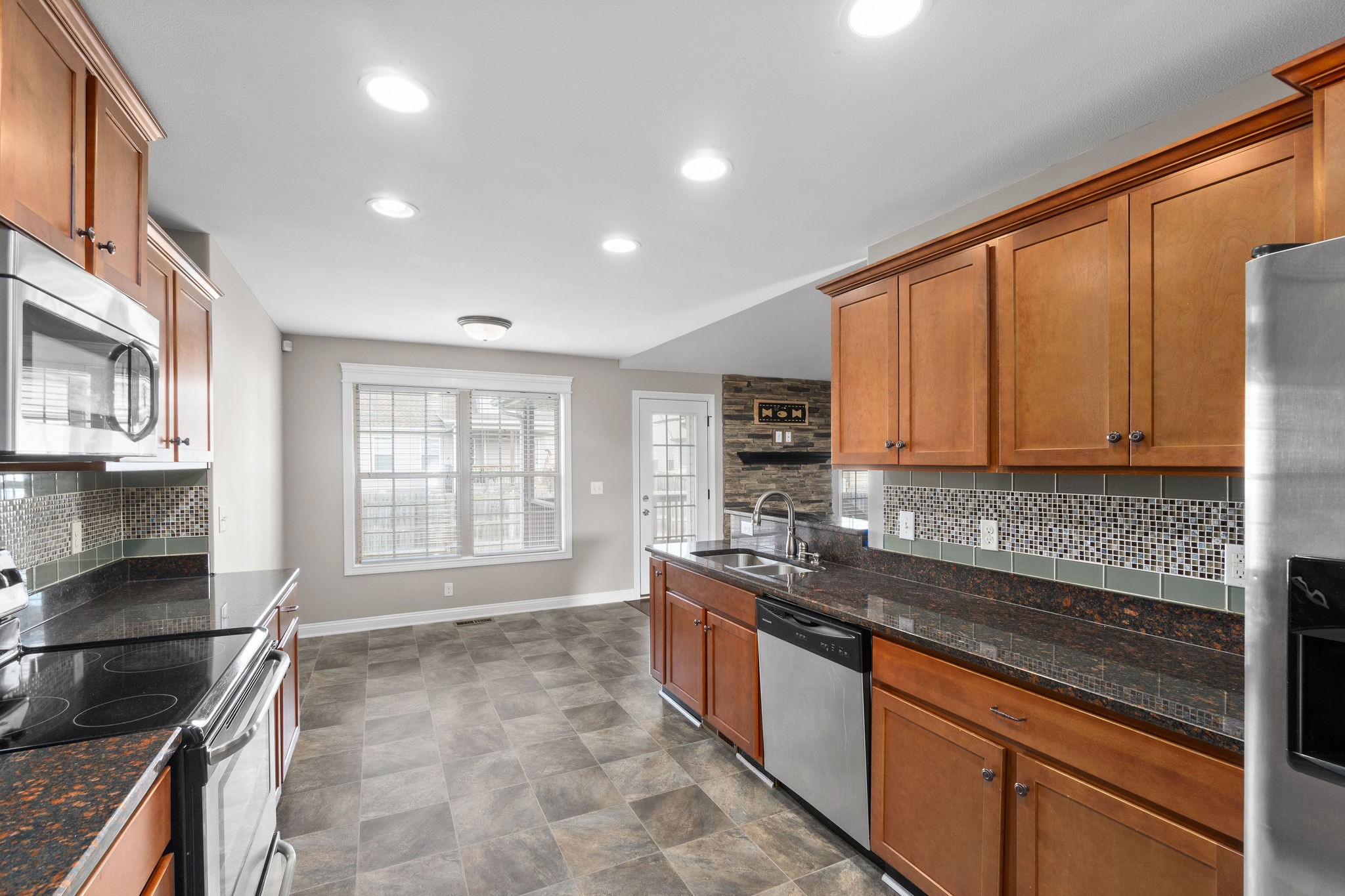 3782 Suiter Road Clarksville, TN 37040 - Photo 16 of 32 a kitchen with stainless steel appliances granite countertop a stove a sink and a microwave