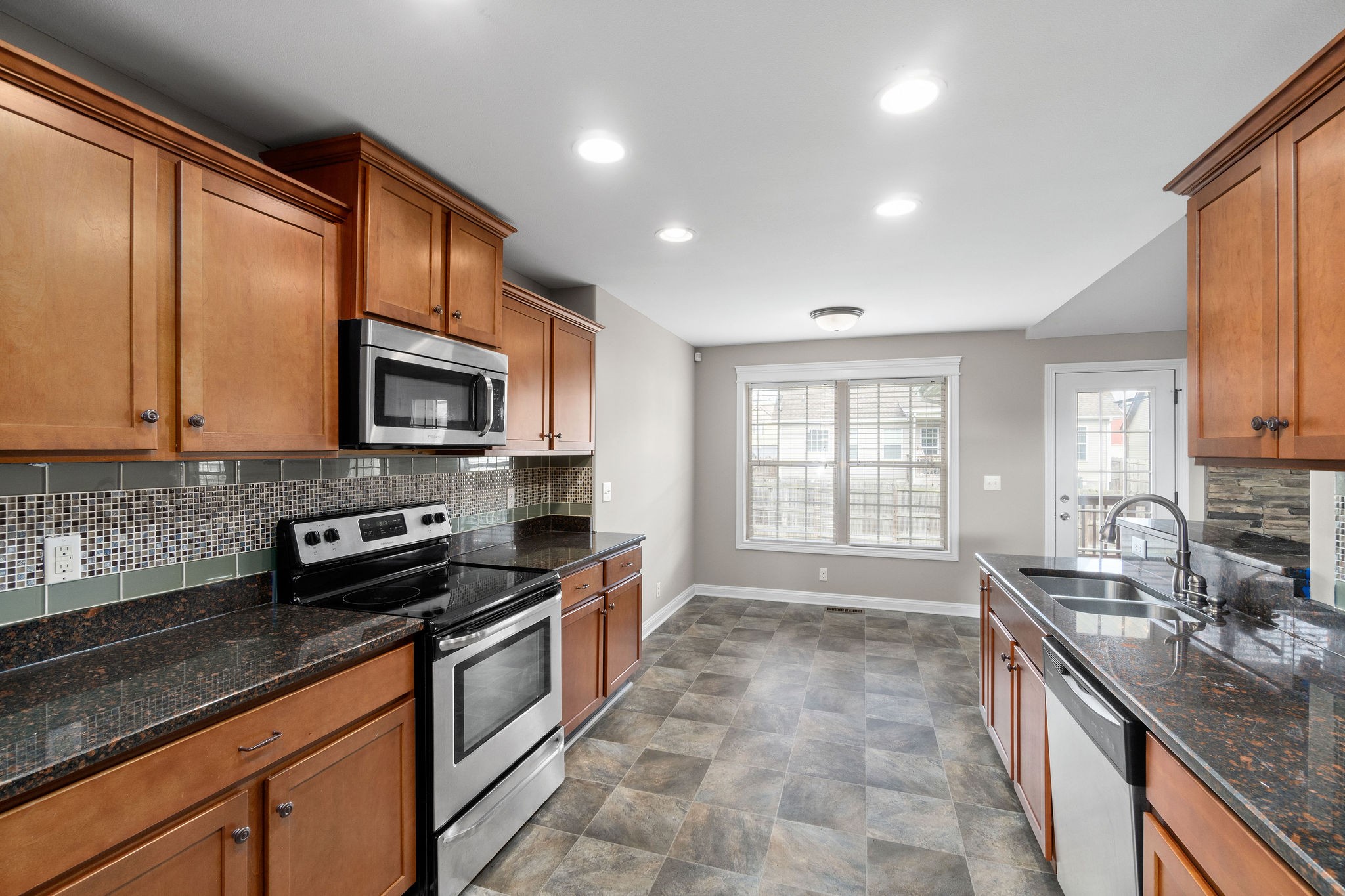 3782 Suiter Road Clarksville, TN 37040 - Photo 18 of 32 a kitchen with stainless steel appliances granite countertop a stove a sink and a microwave