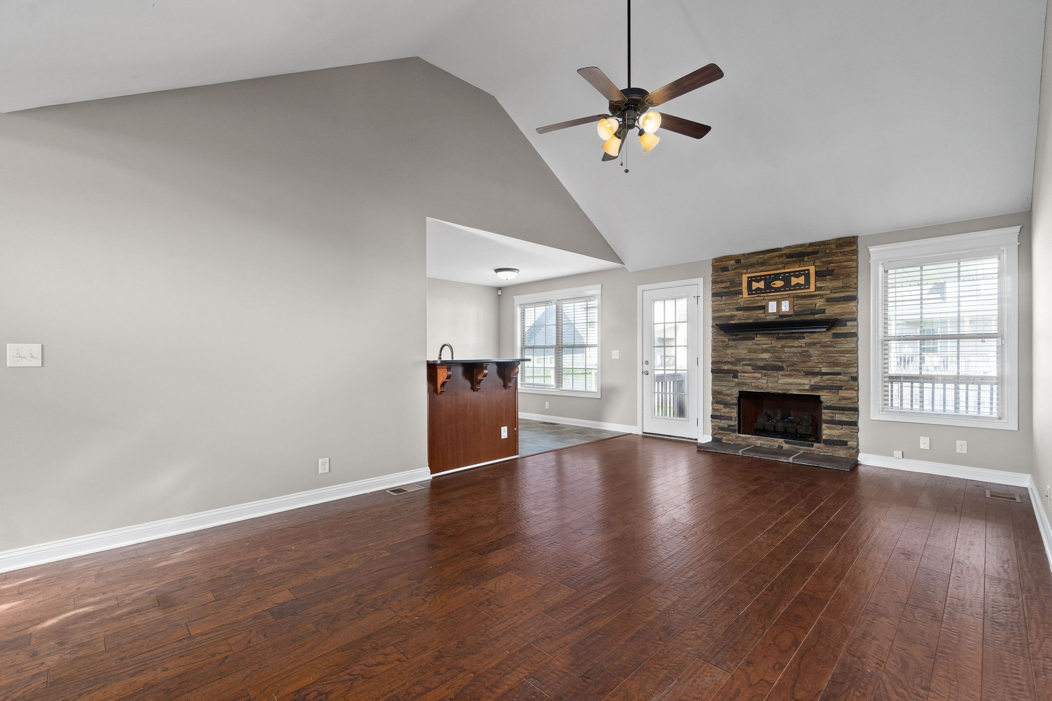 3782 Suiter Road Clarksville, TN 37040 - Photo 8 of 32 a view of a livingroom with a fireplace a ceiling fan and wooden floor