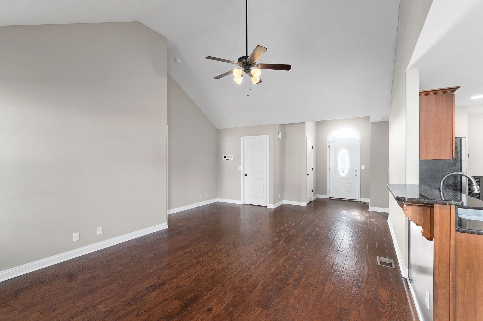 3782 Suiter Road Clarksville, TN 37040 - Photo 9 of 32 a view of a livingroom with a hardwood floor and a ceiling fan