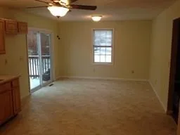 an empty room with windows and entrance