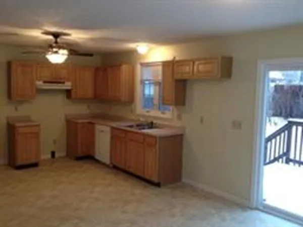 a kitchen with granite countertop a sink cabinets and stainless steel appliances