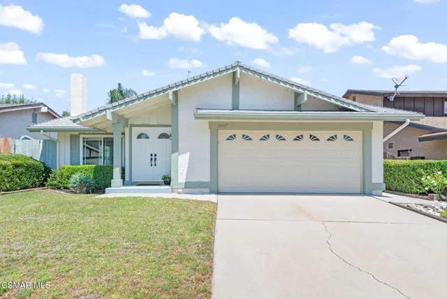 a front view of a house with a garden and entryway
