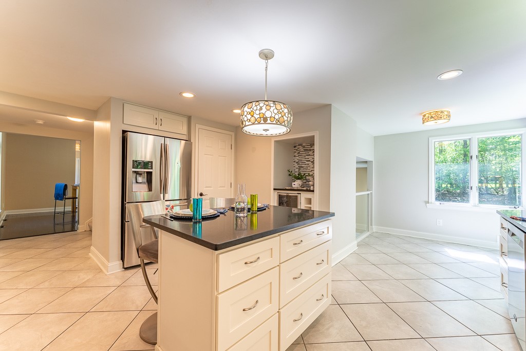 220 Hibiscus Drive Rochester, NY 14618 - Photo 13 of 50 A curated coffee bar with beverage fridge and wine storage, along with a generous pantry, adds both luxury and practicality.