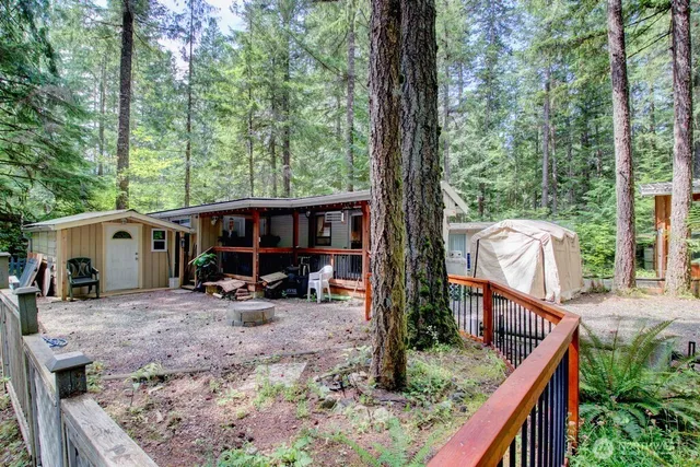 a view of house with furniture in backyard