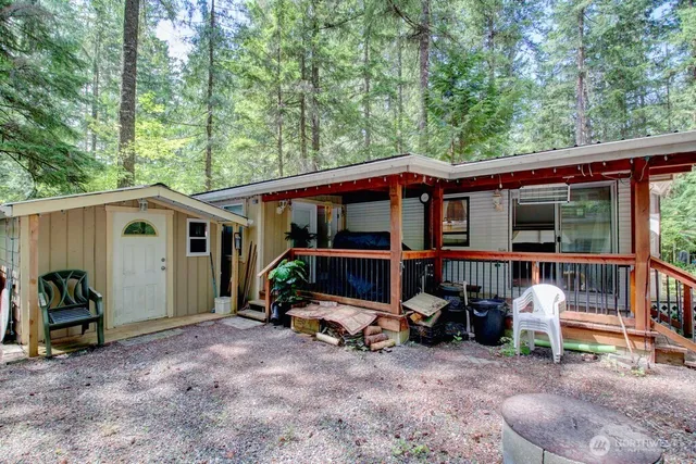 a view of a house with a yard and furniture