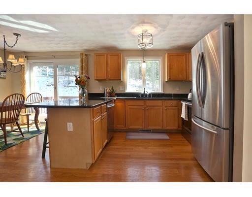 8 Adeline Road Ipswich, MA 01938 - Photo 9 of 28 a kitchen with stainless steel appliances granite countertop a refrigerator a sink dishwasher a stove with wooden cabinets and floor