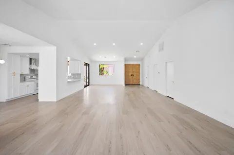 a view of an empty room and wooden floor