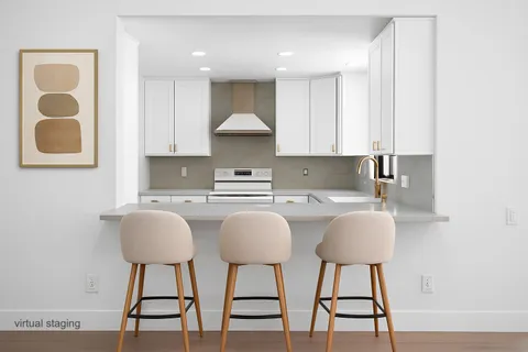 a kitchen with stainless steel appliances granite countertop a sink and a stove