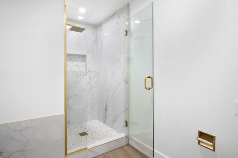 a bathroom with a glass shower door