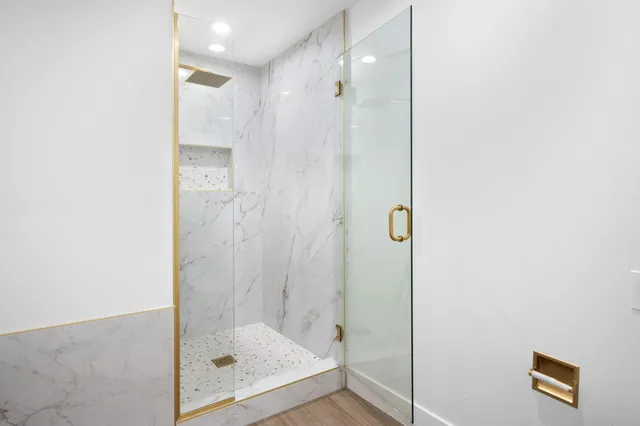a bathroom with a glass shower door