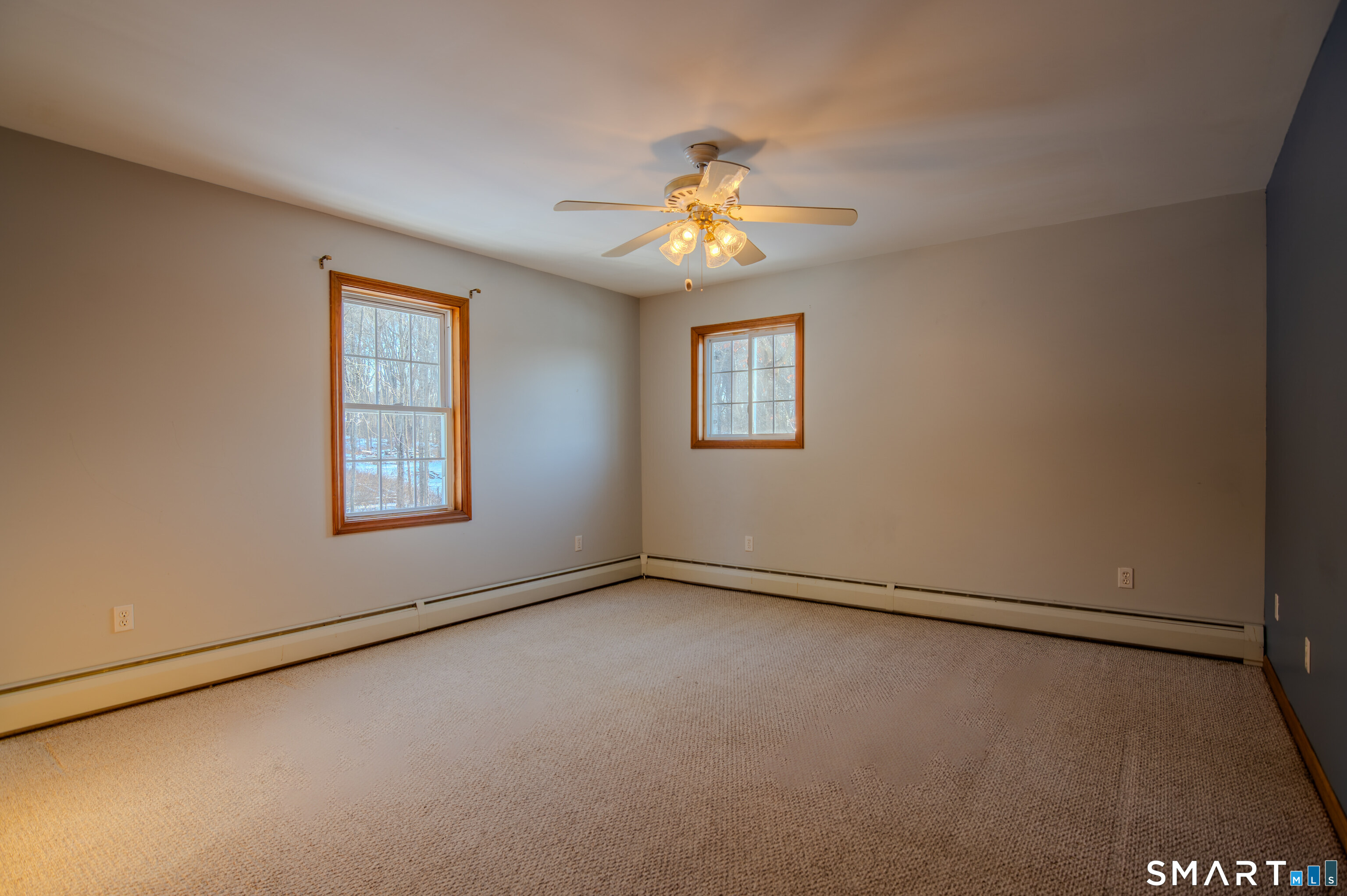 8 Juniper Lane Plainfield, CT 06354 - Photo 19 of 37 an empty room with windows and fan