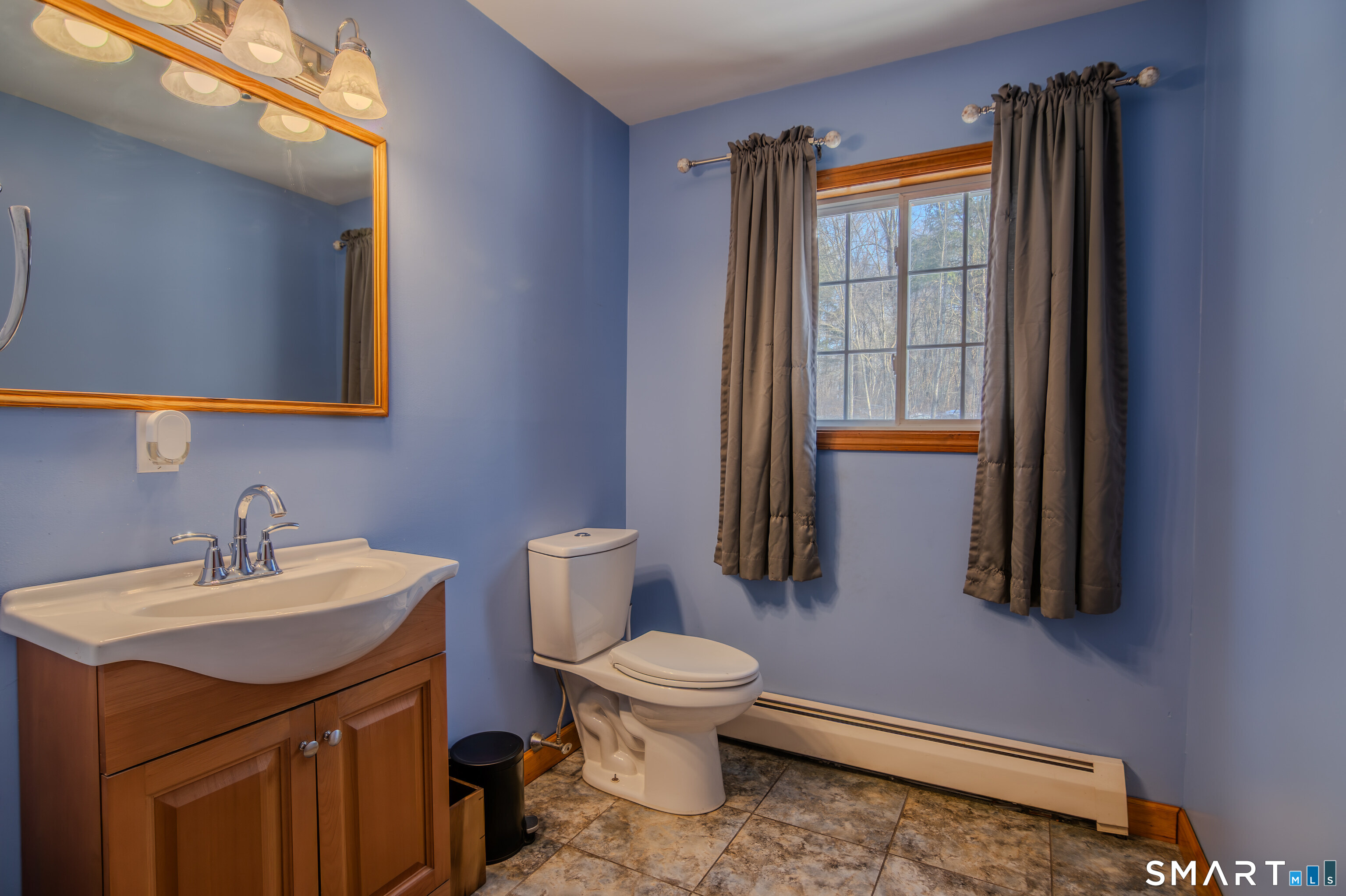 8 Juniper Lane Plainfield, CT 06354 - Photo 29 of 37 a bathroom with a sink a toilet and mirror