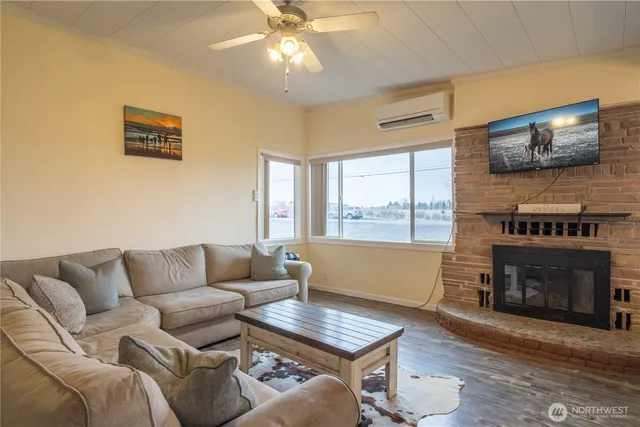 a living room with furniture a flat screen tv and a fireplace