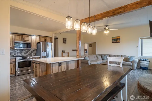 a large kitchen with a table and chairs