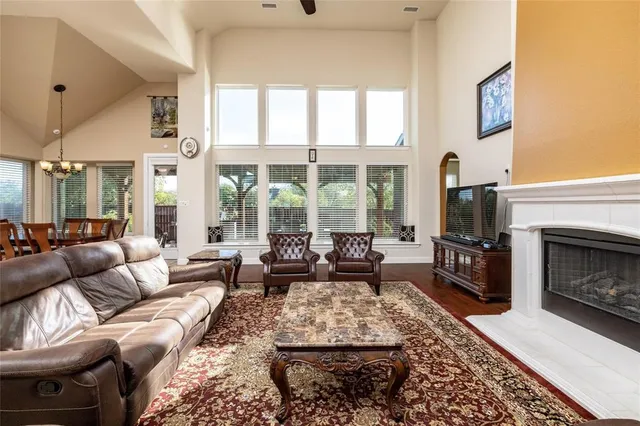a living room with furniture large window and a fireplace