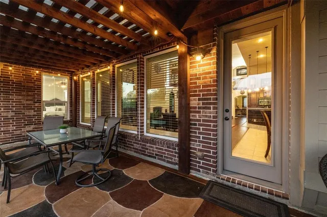 a view of a dining room with furniture and a window