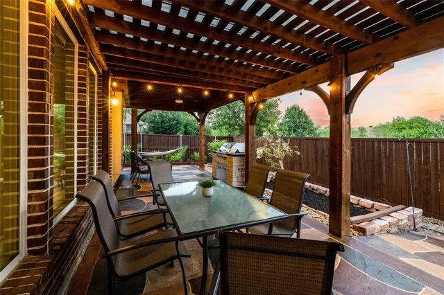 a view of a patio with a table chairs and a backyard