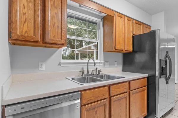 a kitchen with stainless steel appliances granite countertop a sink and a cabinets