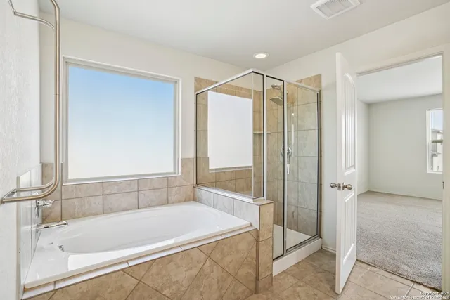 a bathroom with a bathtub and a shower
