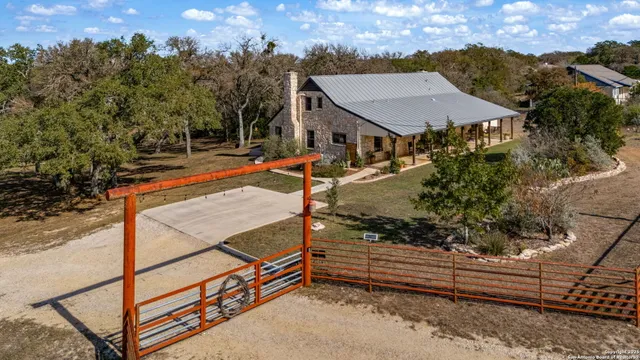a view of a house with wooden fence