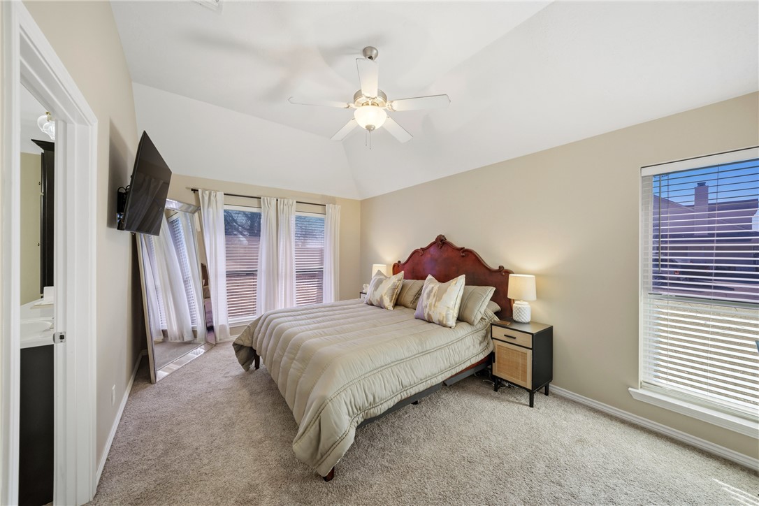 214 Apache Drive Franklin, TX 77856 - Photo 15 of 32 a bedroom with a bed flat screen tv and a chandelier