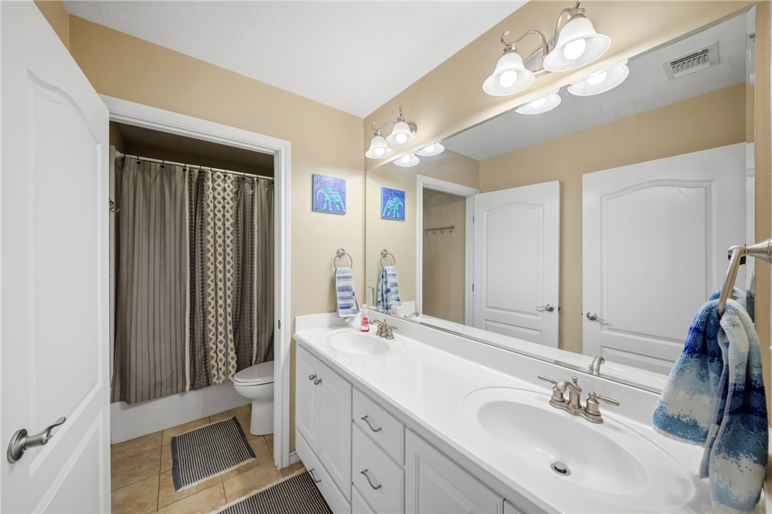 214 Apache Drive Franklin, TX 77856 - Photo 24 of 32 a bathroom with a double vanity sink and a mirror