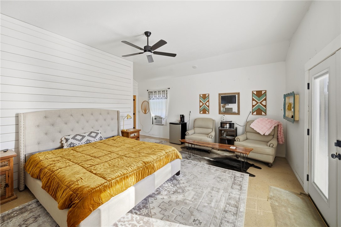 214 Apache Drive Franklin, TX 77856 - Photo 29 of 32 a bedroom with a bed and wooden floor