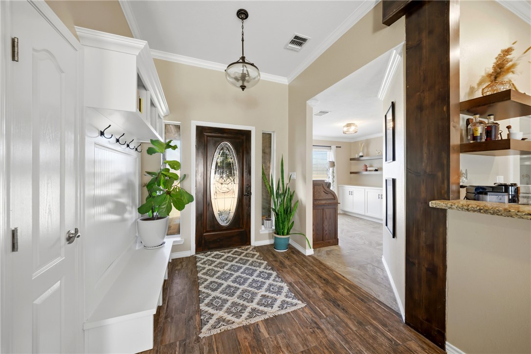 214 Apache Drive Franklin, TX 77856 - Photo 3 of 32 a hallway with a dining table and a fireplace