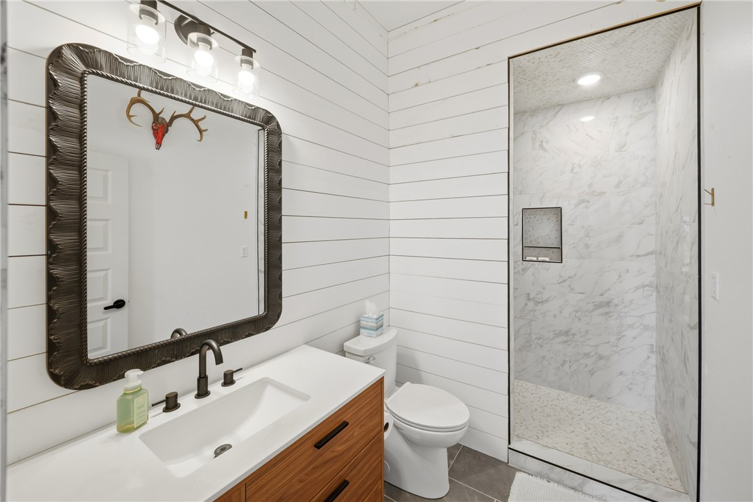 214 Apache Drive Franklin, TX 77856 - Photo 31 of 32 a bathroom with a toilet sink and shower