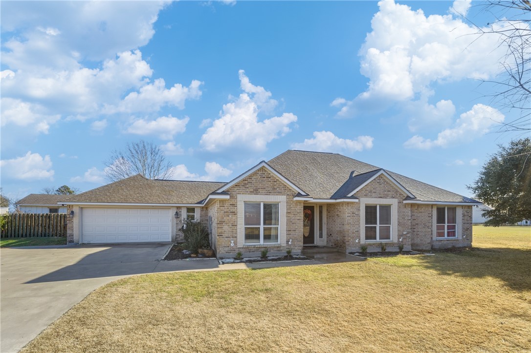 214 Apache Drive Franklin, TX 77856 - Photo 6 of 32 a front view of a house with a garden
