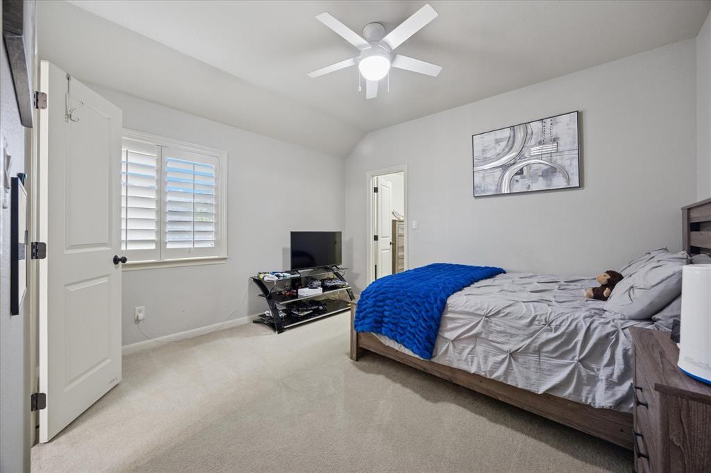 580 Butchart Drive Prosper, TX 75078 - Photo 28 of 40 Bedroom with carpet, lofted ceiling, baseboards, and ceiling fan