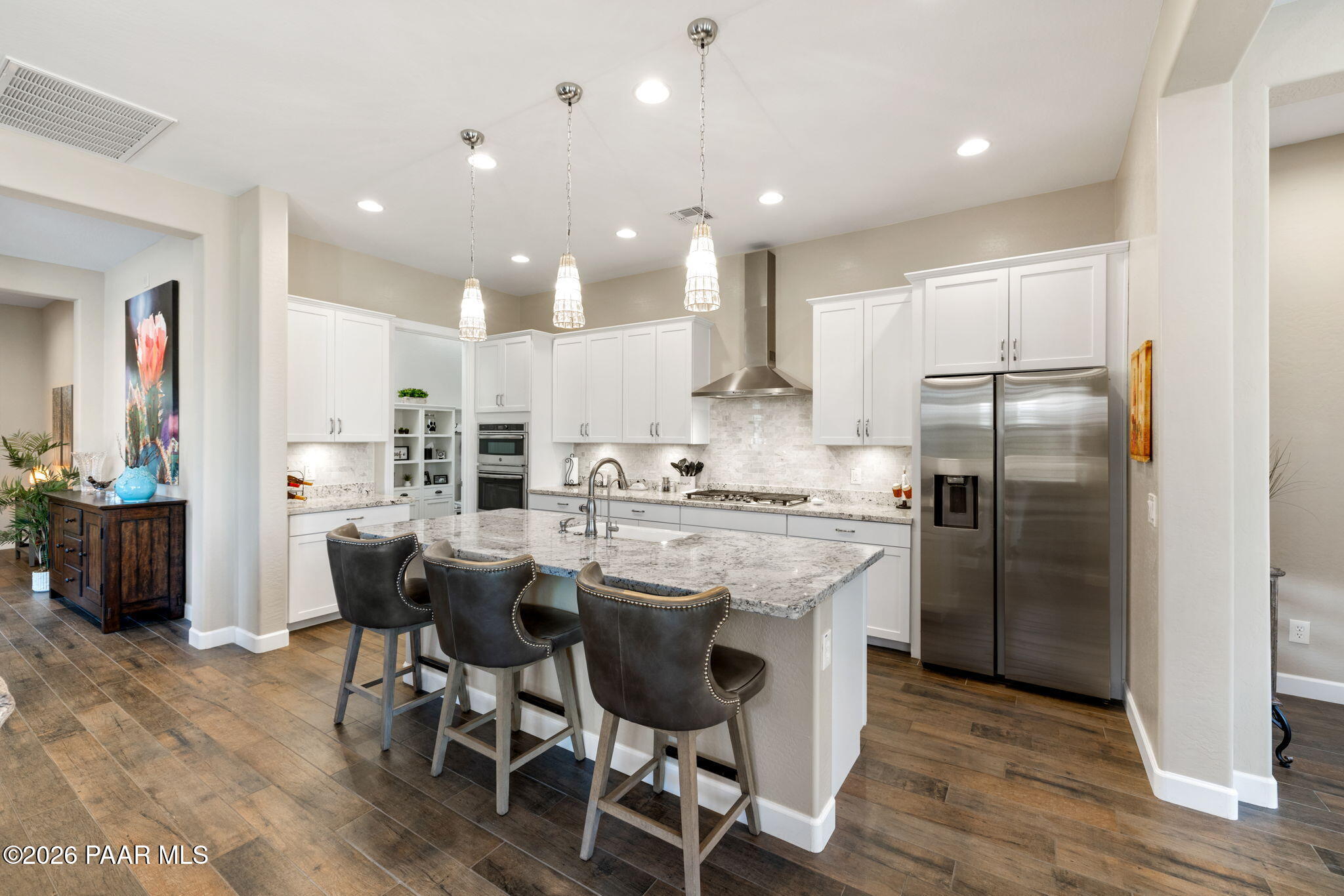 2792 Brooks Range Prescott, AZ 86301 - Photo 18 of 35 a kitchen with kitchen island granite countertop a center island stainless steel appliances cabinets and a counter top space