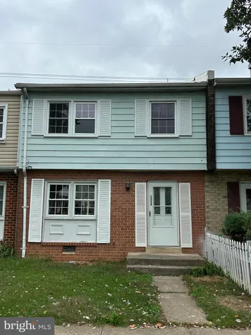a house that has a window in front of a white house