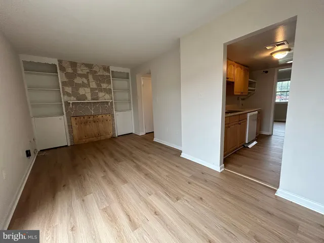 wooden floor in an empty room and a kitchen