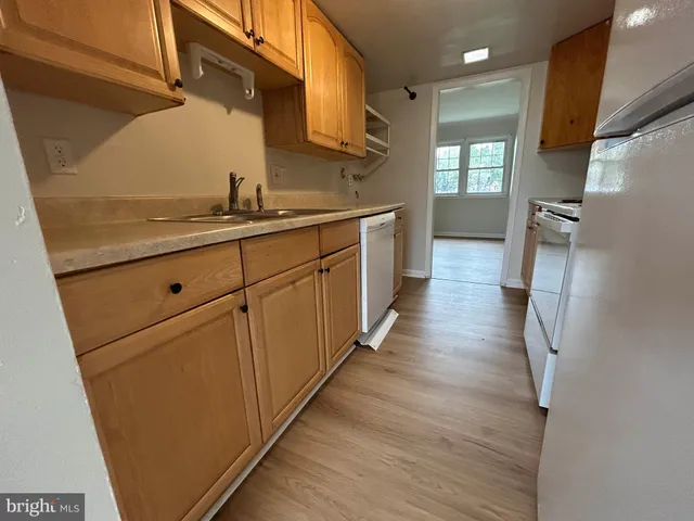a kitchen with stainless steel appliances a refrigerator and a stove top oven