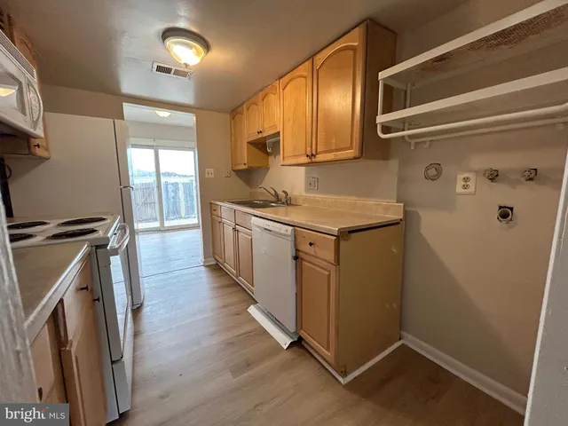 a kitchen with a sink a refrigerator freezer and a stove