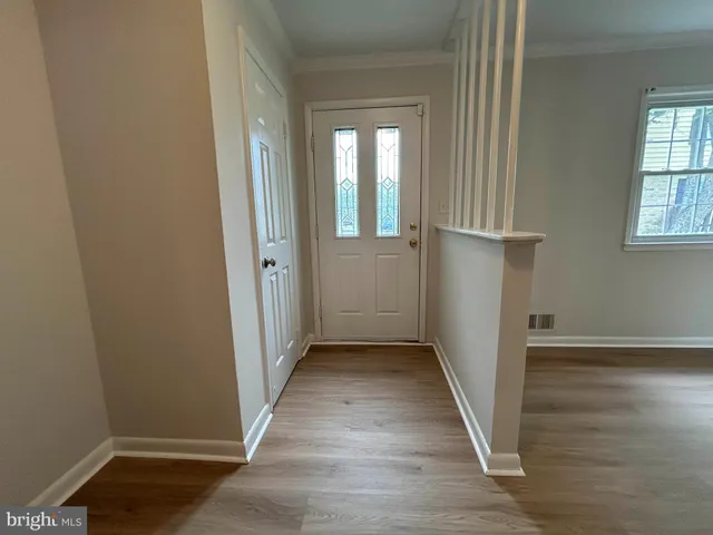 wooden floor in a hallway with a window