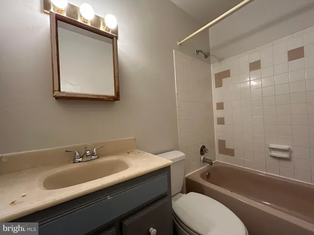 a bathroom with a sink toilet a mirror and shower