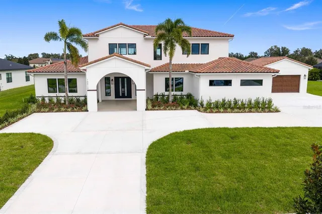 a front view of a house with a yard and garage