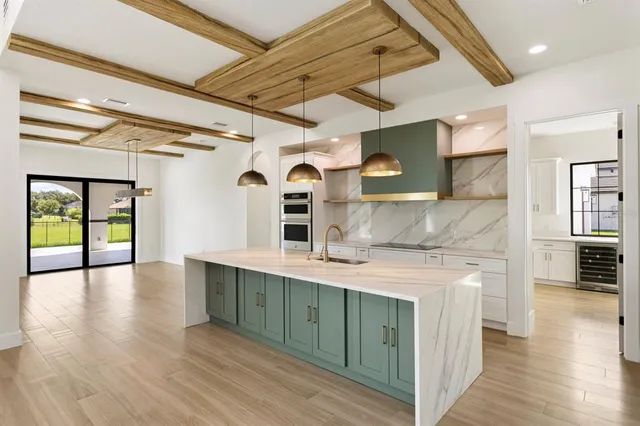 a kitchen with a sink appliances and cabinets