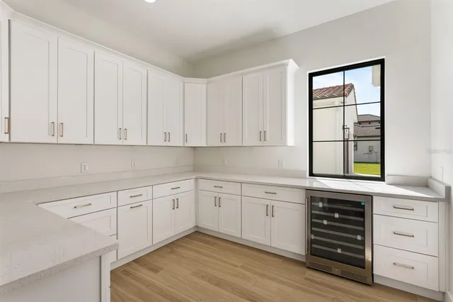 a kitchen with granite countertop white cabinets and white appliances